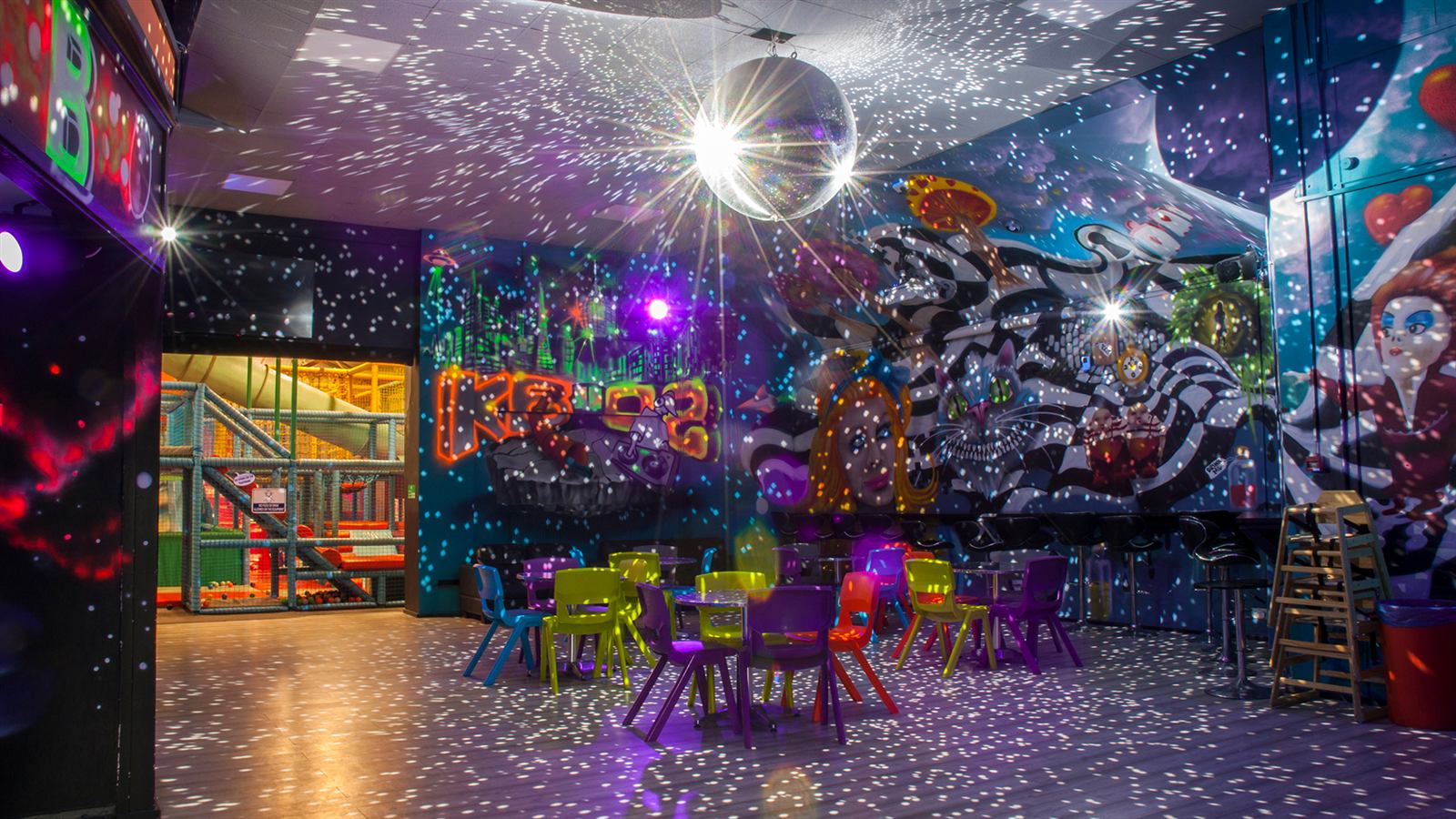 The food area with tables and benches under the mirror ball